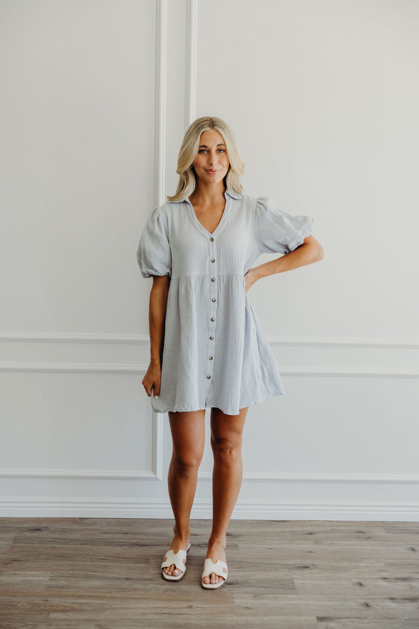 Short blue dress with fit and flare silhouette with button down detail.