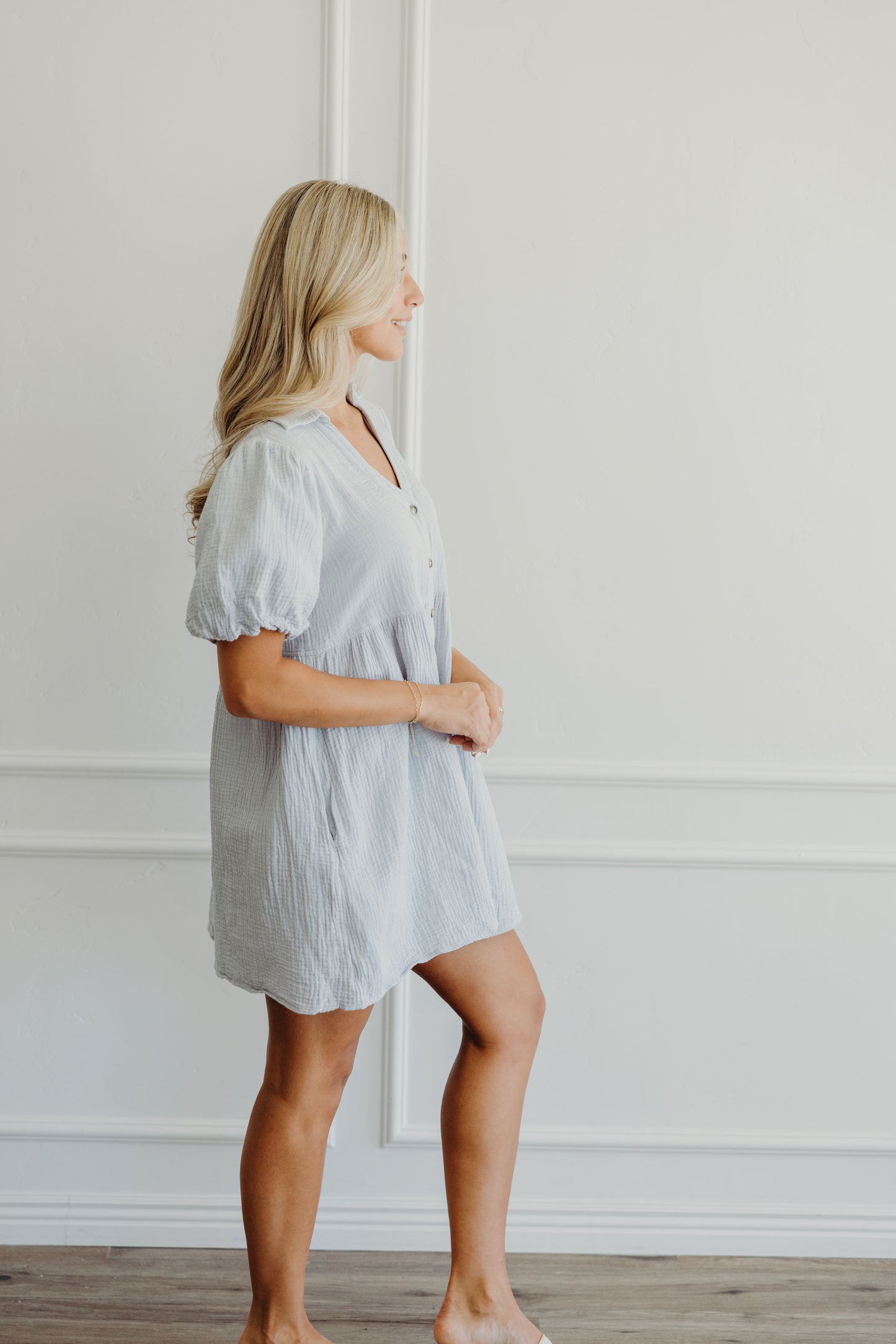 Short blue dress with puff sleeves and v neckline.