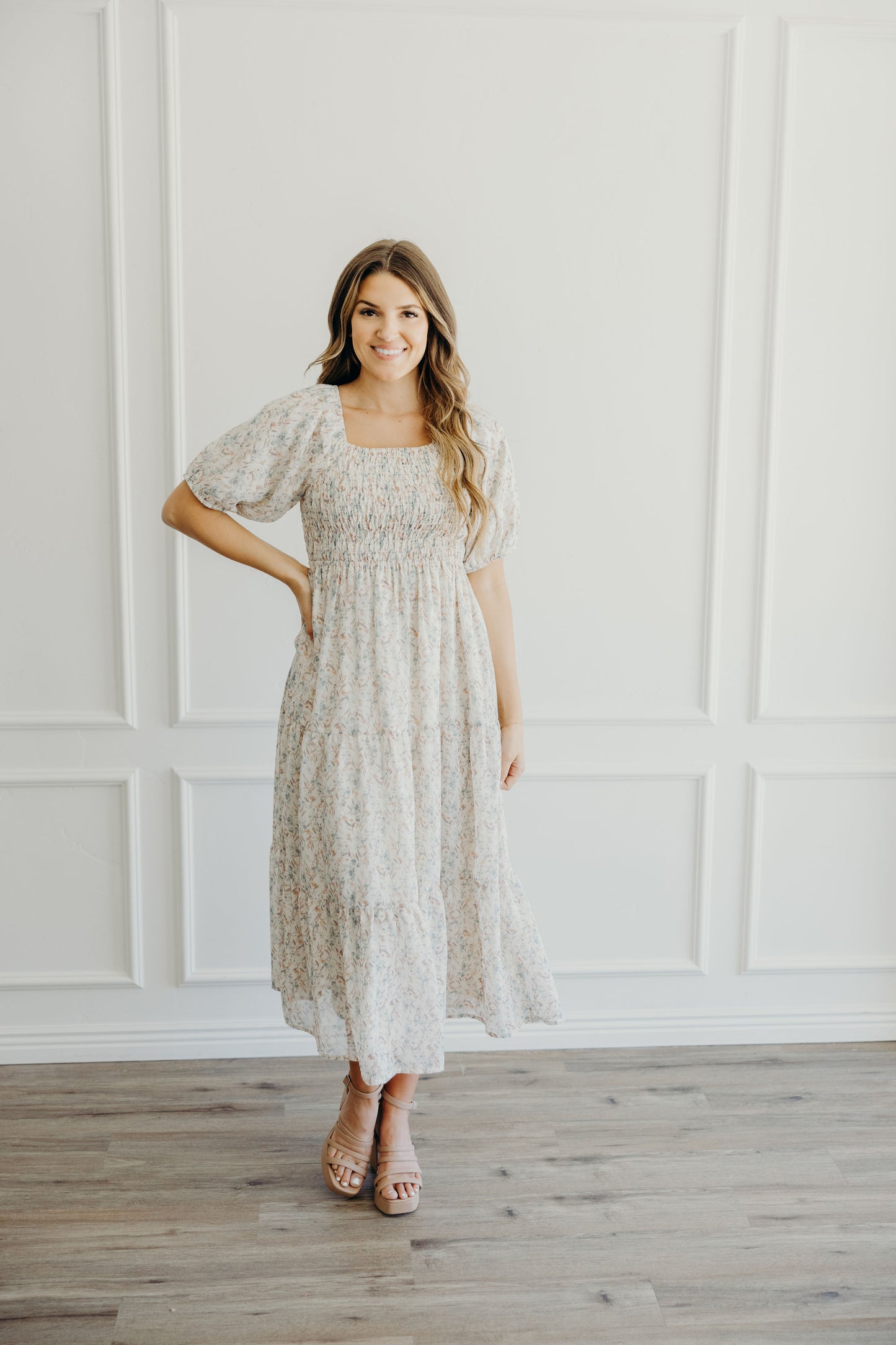 Midi length flower print dress with tiered skirt, smocked bodice, and puff sleeves.