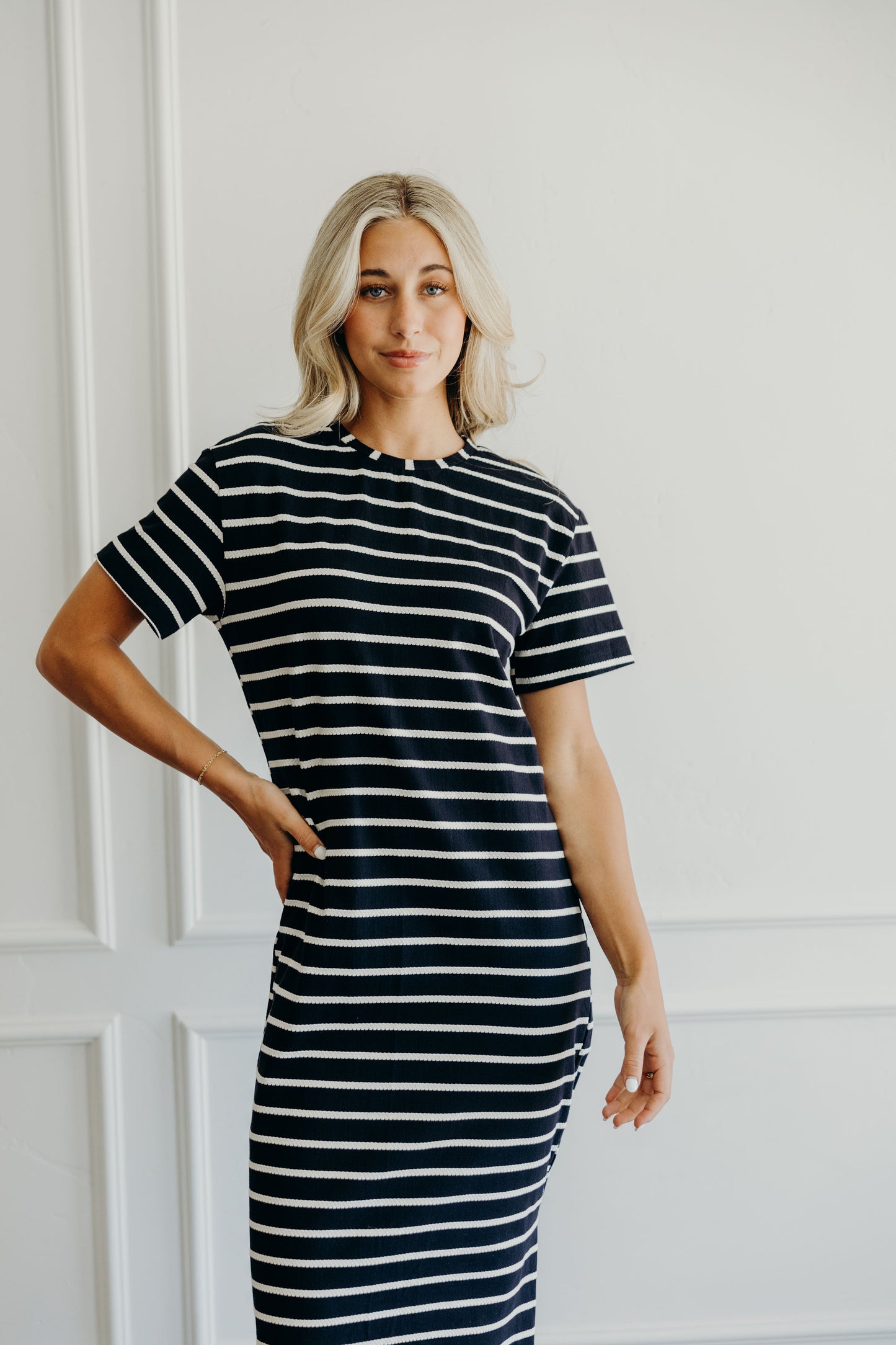 Black and cream textured striped dress with high neckline and short sleeves.