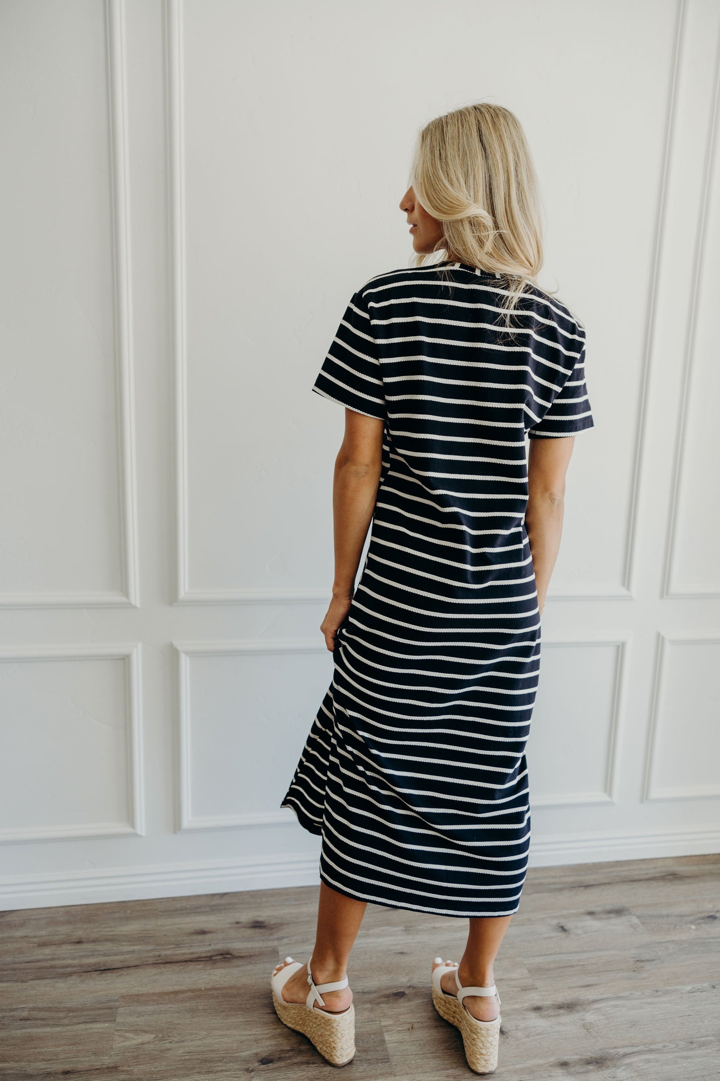 Back view of oversized t shirt midi length dress with black and cream stripes.