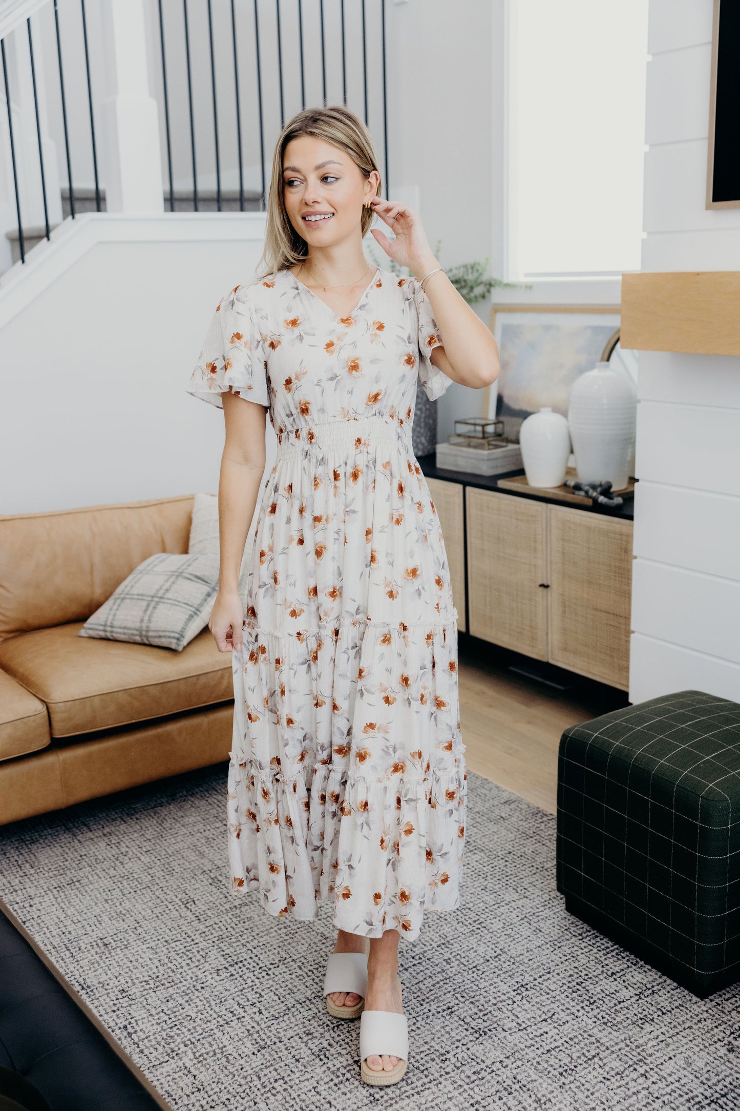 Cream and copper print dress dress with v neckline, short sleeves and tiered skirt.