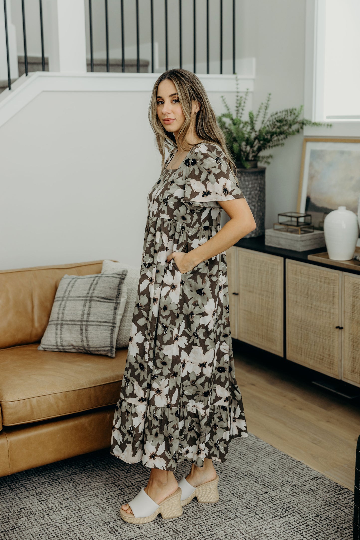 Green floral print midi length dress with with ruffle hem and pockets.
