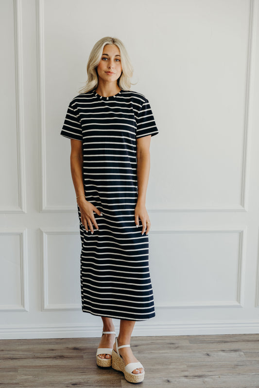 Midi length black dress with striped detail, crew neckline and short sleeves.