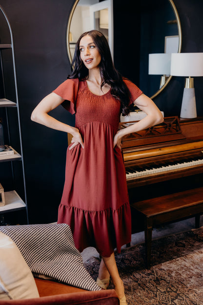Midi length dress with ruffle hem, smocked bodice with natural waistline, v neckline and flutter sleeves.