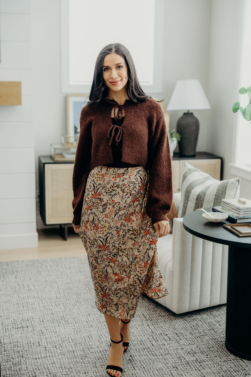 Reddish brown cropped sweater with bow closures.