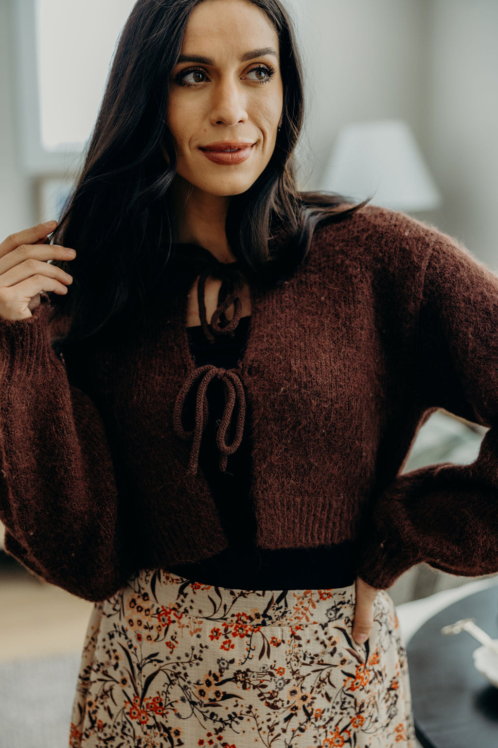 Crop knit sweater with tie closures, ribbed hem and cuff with high neckline.